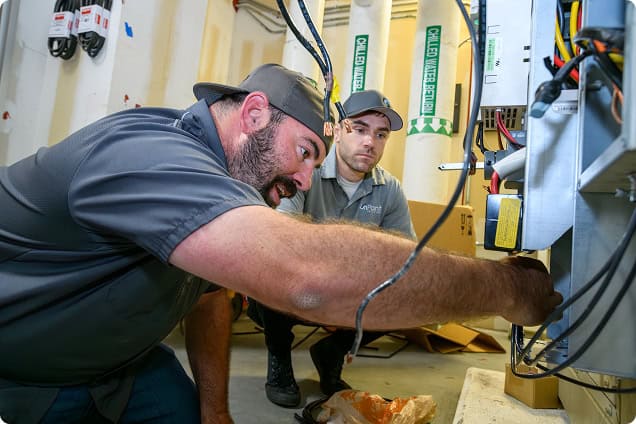 HVAC technicians troubleshooting electrical wiring and components at OnPoint Mechanical. Expert serv.