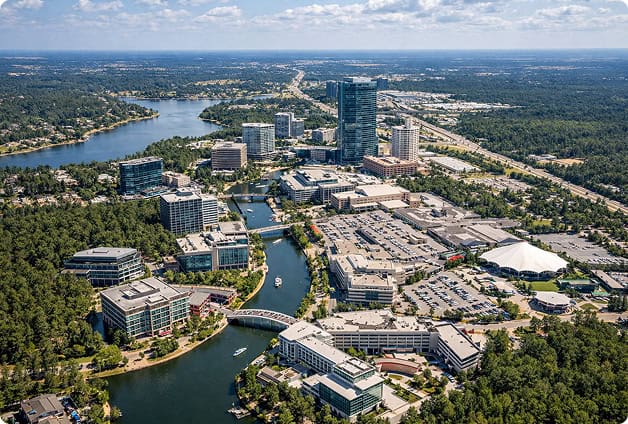 Aerial view of OnPoint Mechanical office complex with modern buildings and waterway in the city cent.